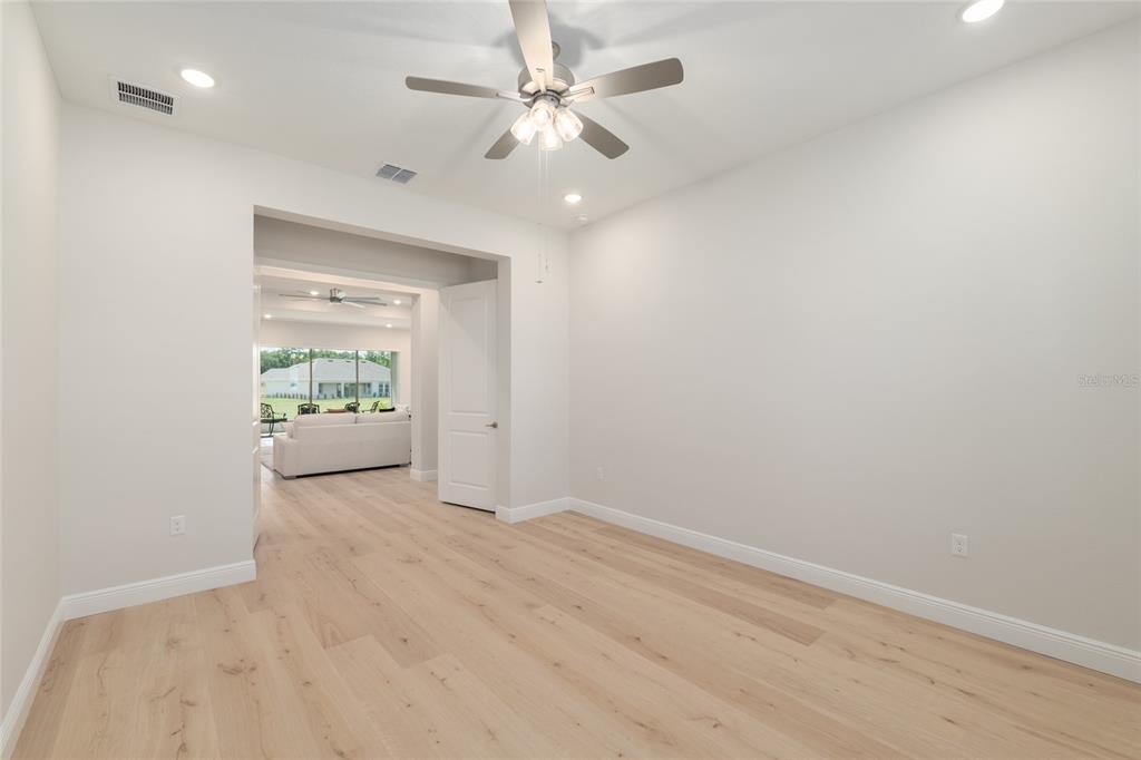 1929 Northwest 85th Loop Ocala, FL 34475 - Photo 37 of 55 wooden floor in an empty room with a window