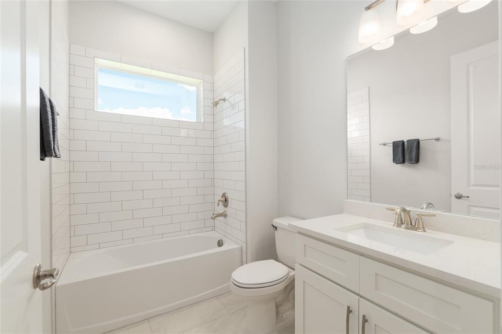 1929 Northwest 85th Loop Ocala, FL 34475 - Photo 41 of 55 a bathroom with a sink a toilet and shower