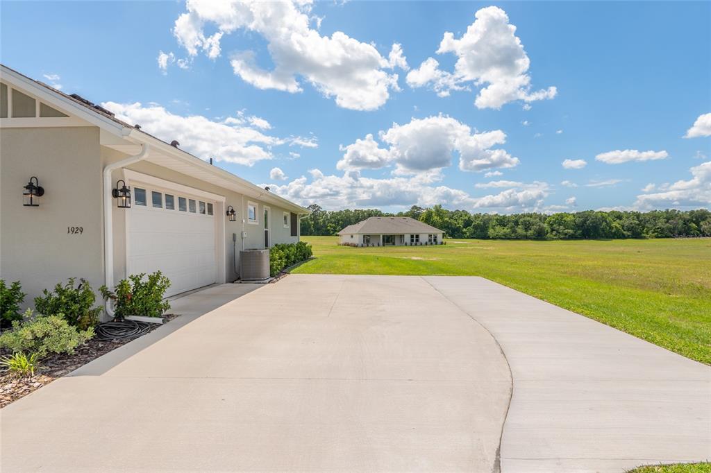 1929 Northwest 85th Loop Ocala, FL 34475 - Photo 5 of 55 a view of a house with a yard and potted plants