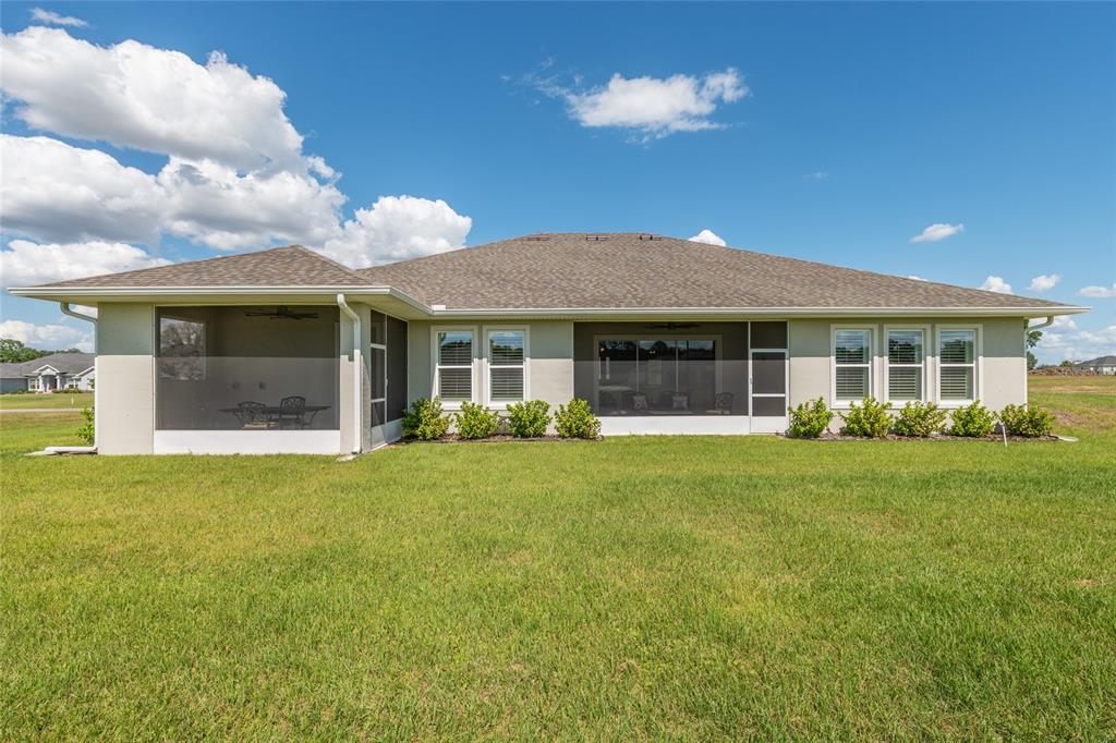 1929 Northwest 85th Loop Ocala, FL 34475 - Photo 52 of 55 a front view of a house with a garden