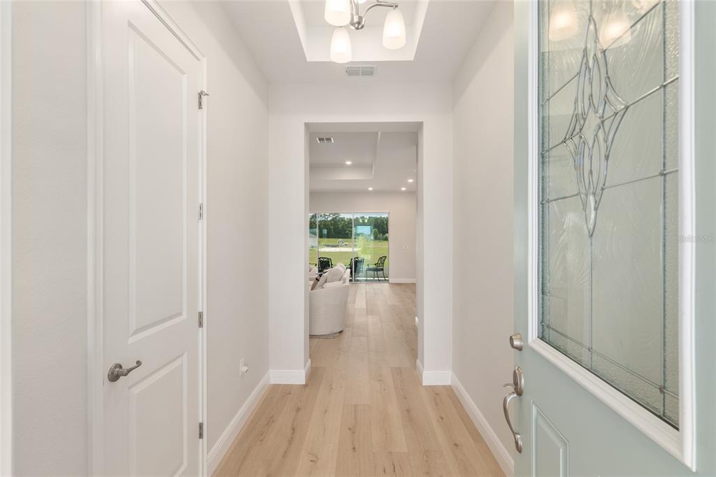 1929 Northwest 85th Loop Ocala, FL 34475 - Photo 10 of 55 a view of a hallway with wooden floor and a bathroom