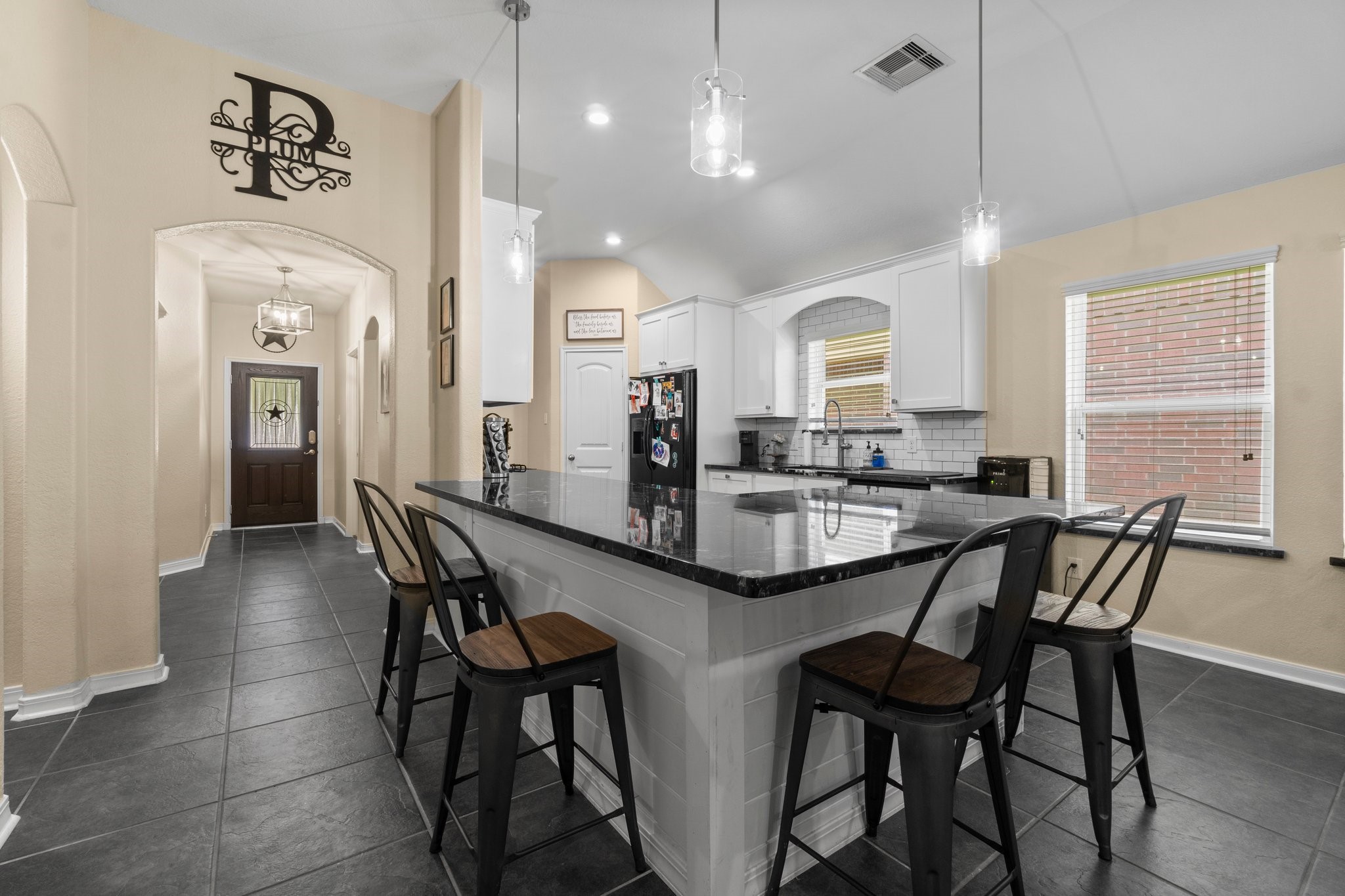 28987 Birch Green Way Spring, TX 77386 - Photo 4 of 32 a kitchen with stainless steel appliances kitchen island granite countertop a dining table chairs and a refrigerator