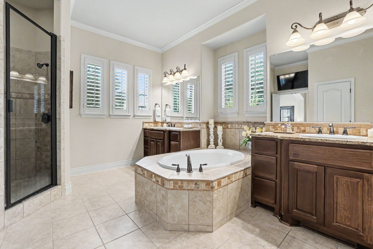 809 Prairie Dunes Drive Georgetown, TX 78628 - Photo 18 of 40 Indulge in a primary bathroom featuring a spacious soaking tub and an elegant tiled shower enclosure.