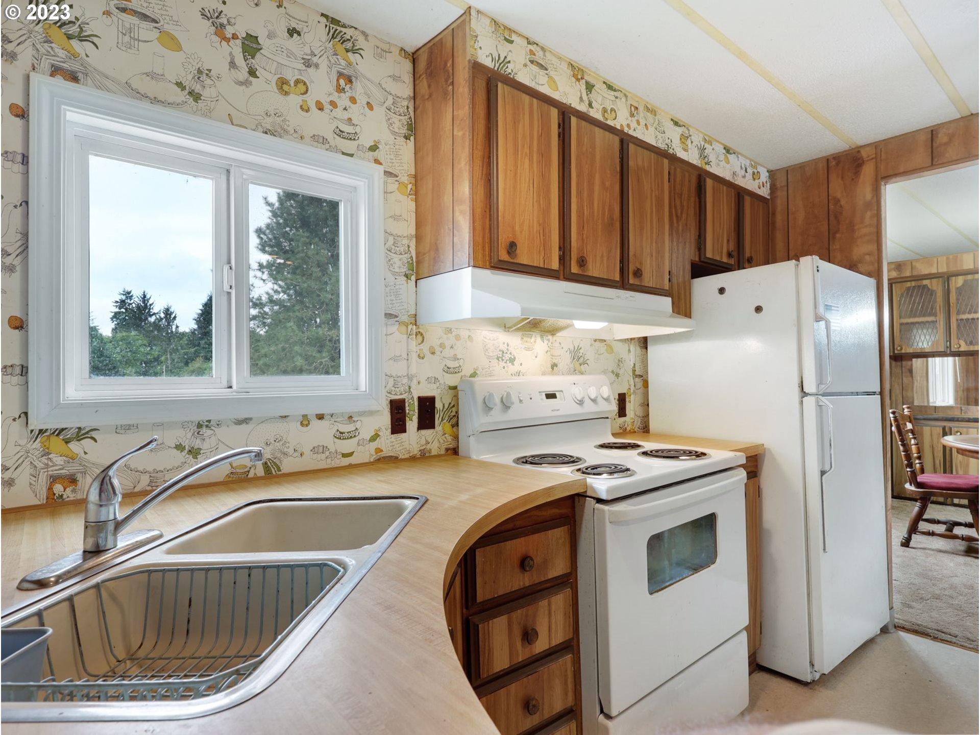 92074 Maki Road Astoria, OR 97103 - Photo 12 of 36 a kitchen with a refrigerator a sink and cabinets