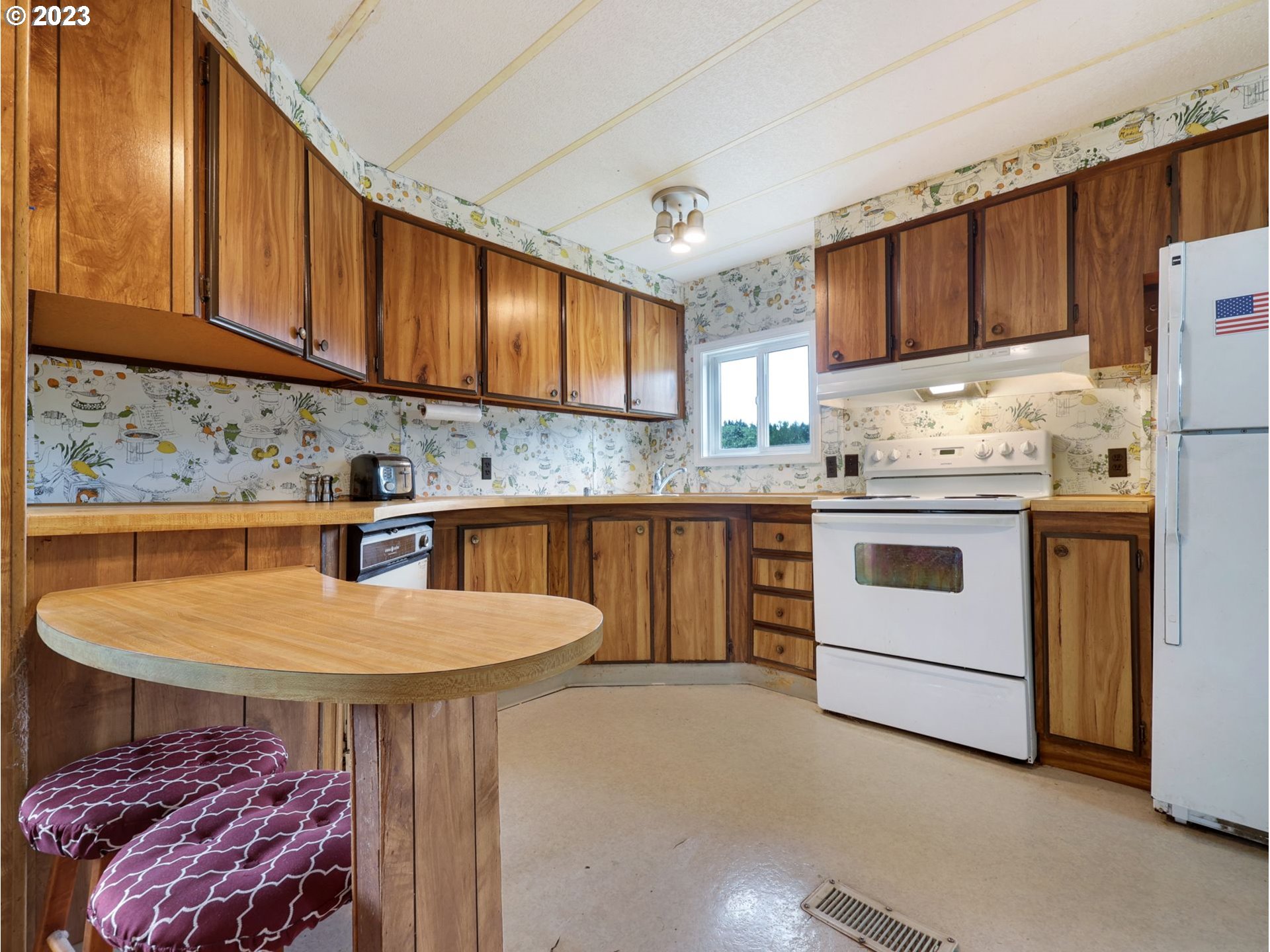 92074 Maki Road Astoria, OR 97103 - Photo 14 of 36 a kitchen with a sink a stove cabinets dining table and utility