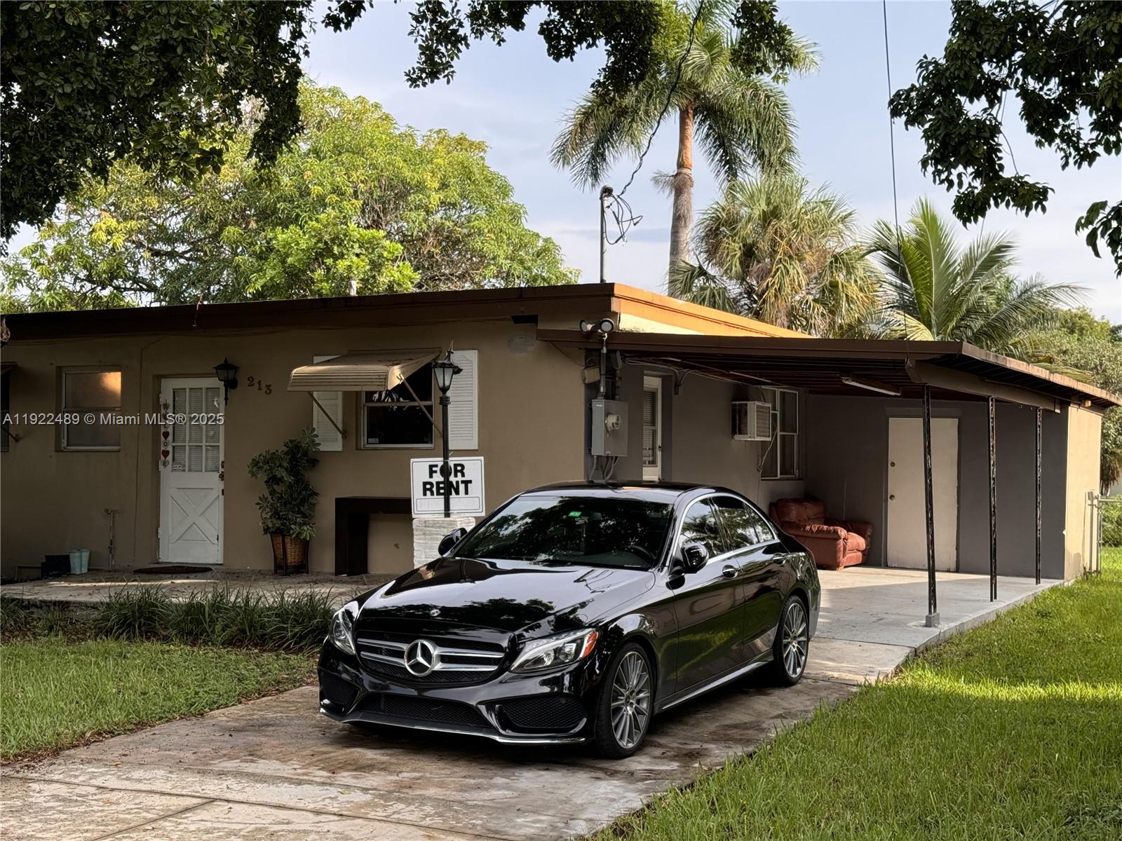 213 Southwest 5th Street Hallandale Beach, FL 33009 - Photo 1 of 17 a car parked in front of a house