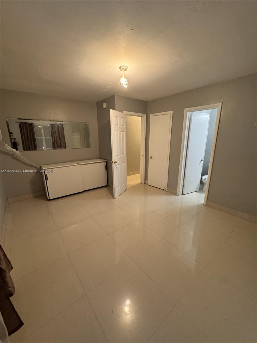 213 Southwest 5th Street Hallandale Beach, FL 33009 - Photo 11 of 17 a spacious bedroom with a bed and a window