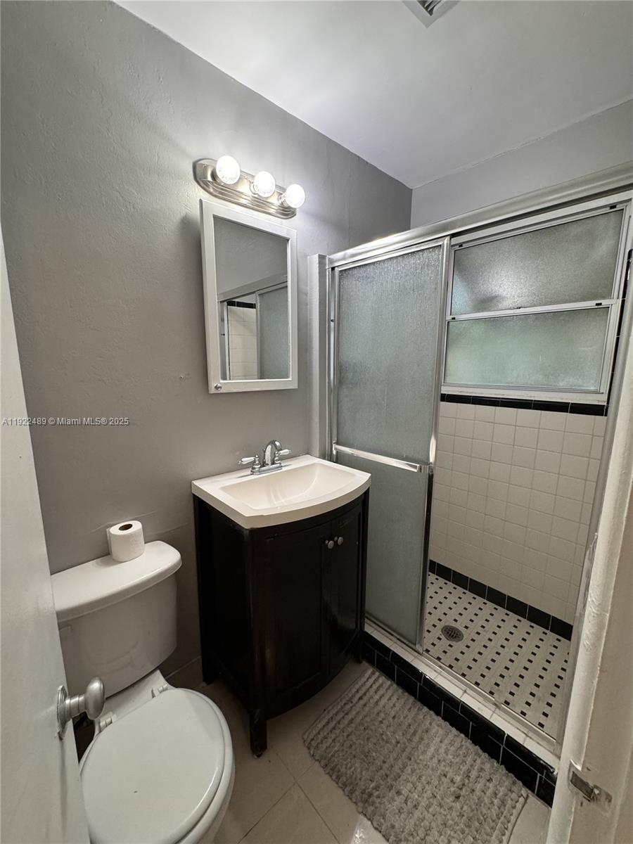 213 Southwest 5th Street Hallandale Beach, FL 33009 - Photo 12 of 17 a bathroom with a sink toilet and shower
