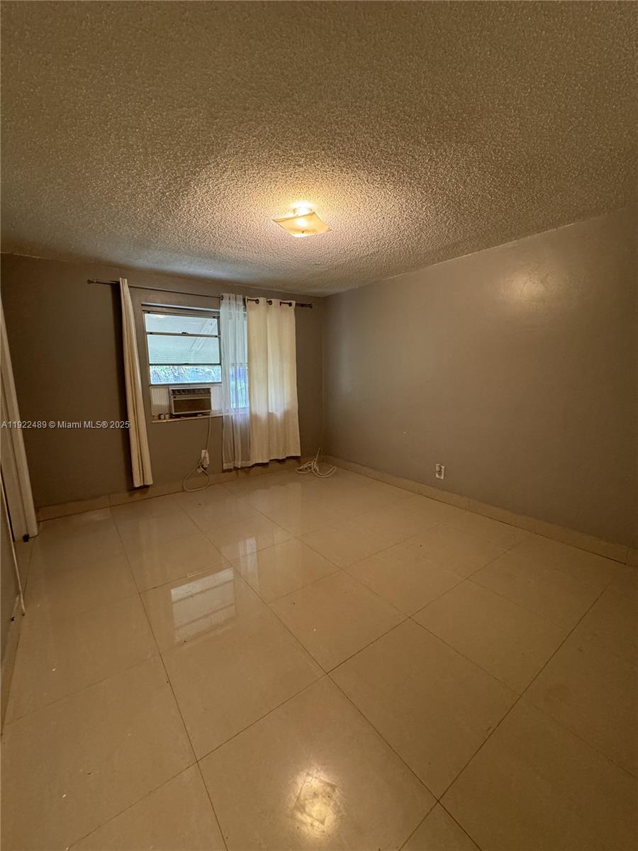 213 Southwest 5th Street Hallandale Beach, FL 33009 - Photo 14 of 17 an empty room with windows