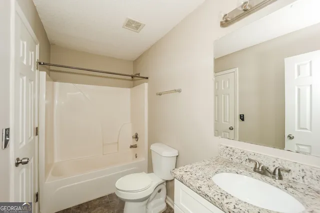 a bathroom with a toilet and shower