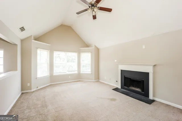 a view of a livingroom with a ceiling fan and window