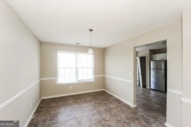 a kitchen with granite countertop a refrigerator sink and cabinets
