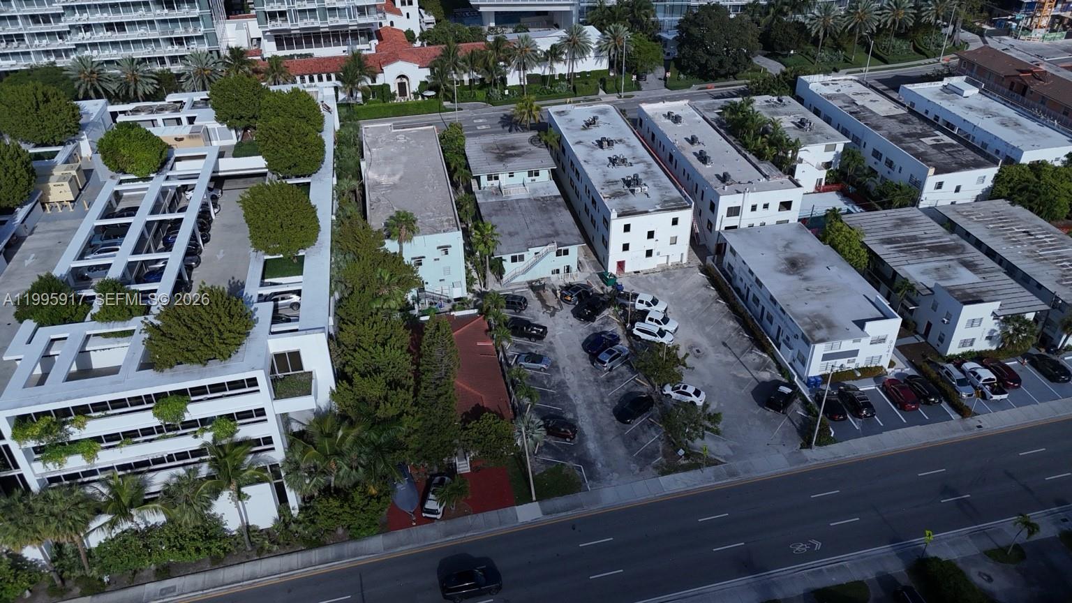 9056 Collins Avenue, Unit 23 Surfside, FL 33154 - Photo 11 of 12 an aerial view of a residential apartment building with plants and large trees