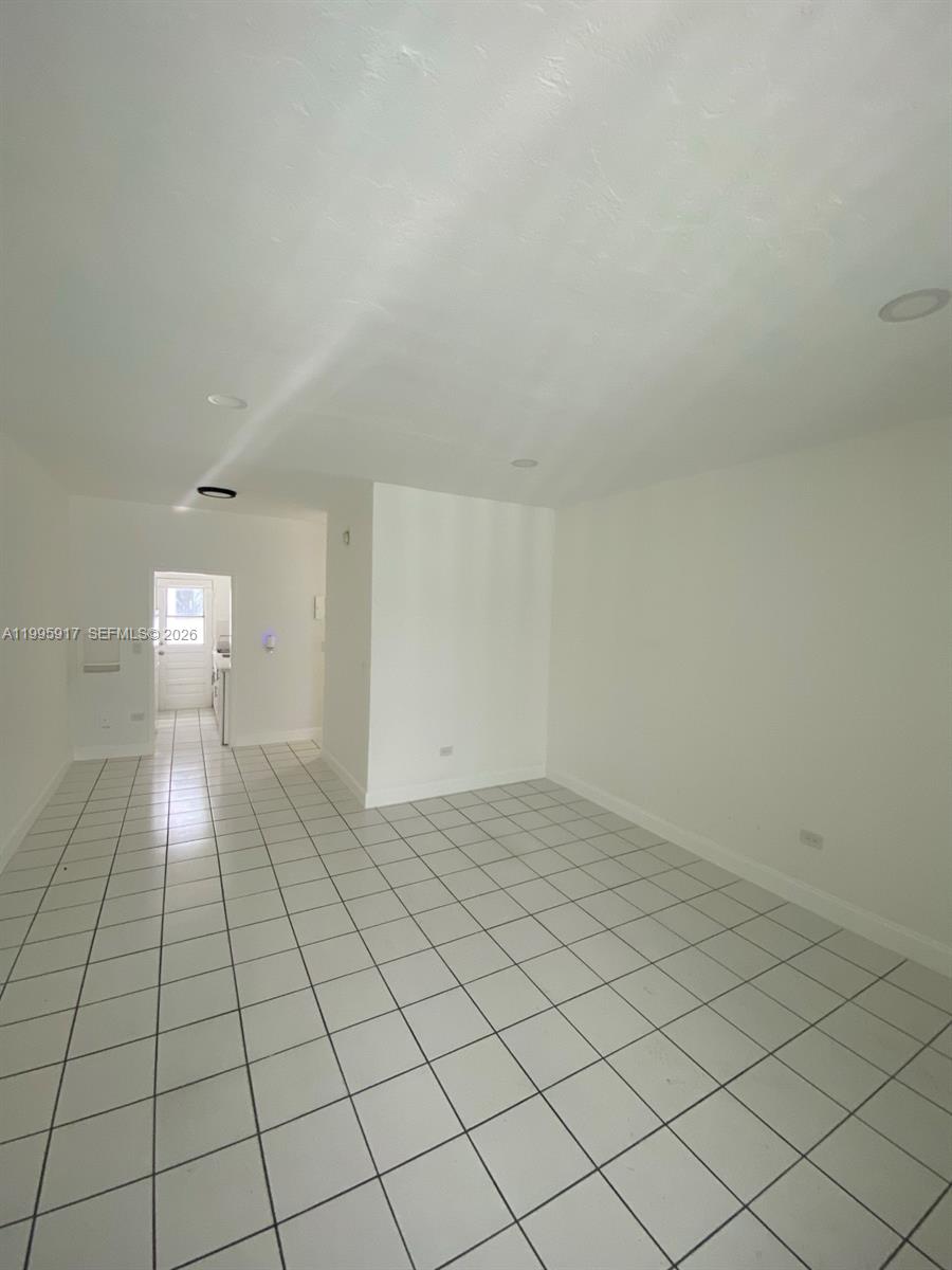 9056 Collins Avenue, Unit 23 Surfside, FL 33154 - Photo 5 of 12 a view of empty room with wooden floor