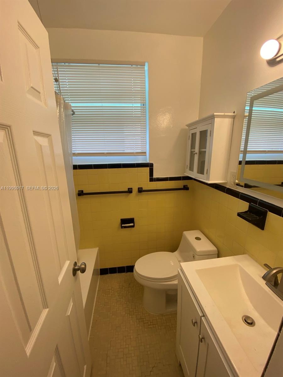 9056 Collins Avenue, Unit 23 Surfside, FL 33154 - Photo 8 of 12 a bathroom with a sink a toilet and shower
