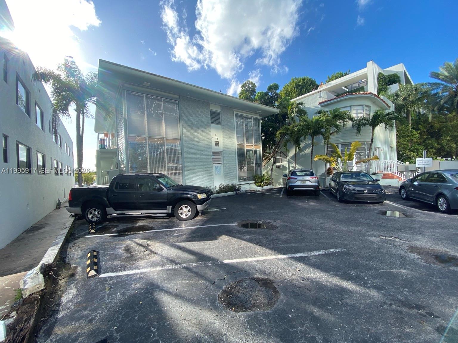 9056 Collins Avenue, Unit 23 Surfside, FL 33154 - Photo 9 of 12 a view of a cars park in front of building