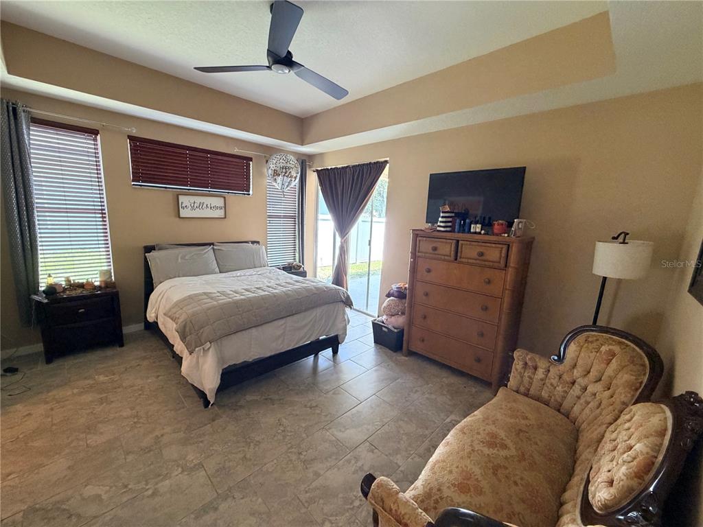 13250 Mandalay Place Spring Hill, FL 34609 - Photo 12 of 28 a bedroom with a bed and furniture