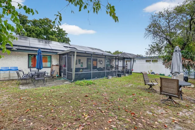 a view of a house with backyard porch and sitting area