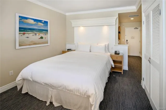 a bedroom with bed and wall painting