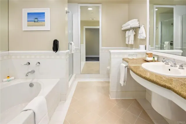 a bathroom with a tub sink and mirror
