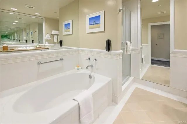 a bathroom with a tub sink and mirror