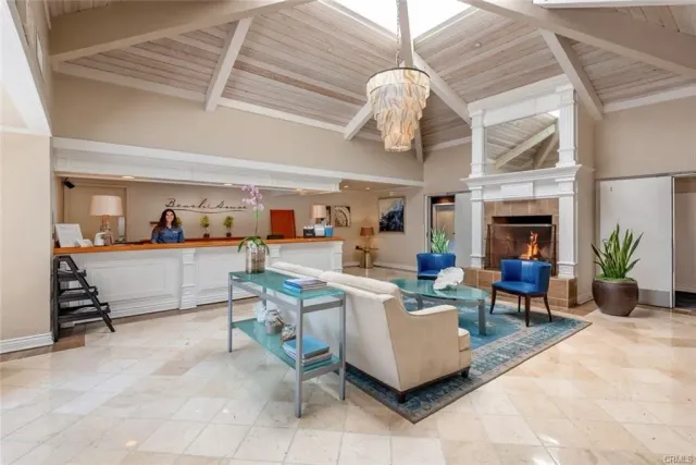 a living room with fireplace furniture and a chandelier