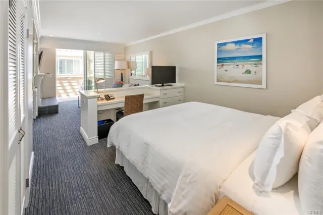 a spacious bedroom with a bed and a flat screen tv