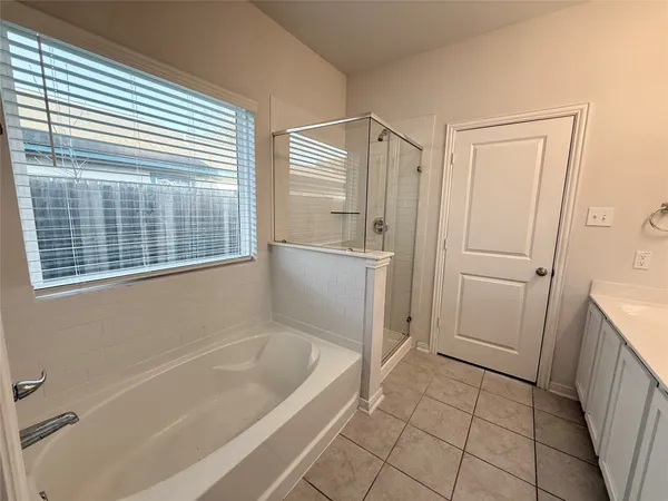 a bathroom with a bathtub and a shower
