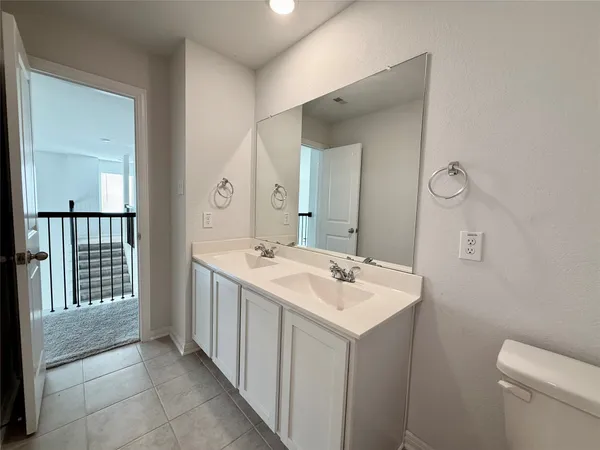 a bathroom with a sink a toilet and mirror