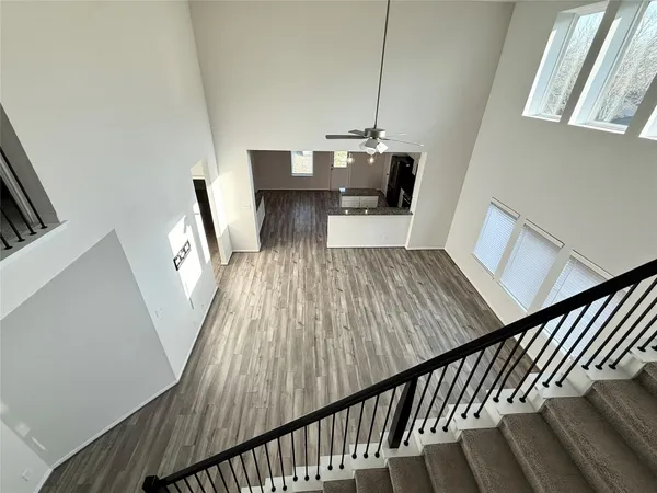 a view of entryway and hall with wooden floor