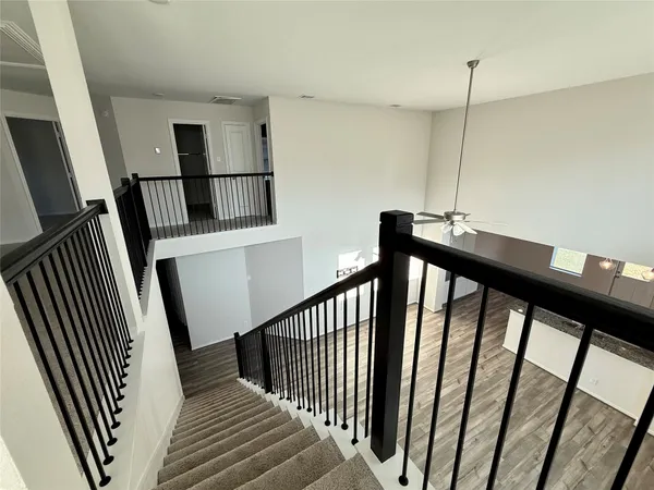 a view of entryway and hall with wooden floor
