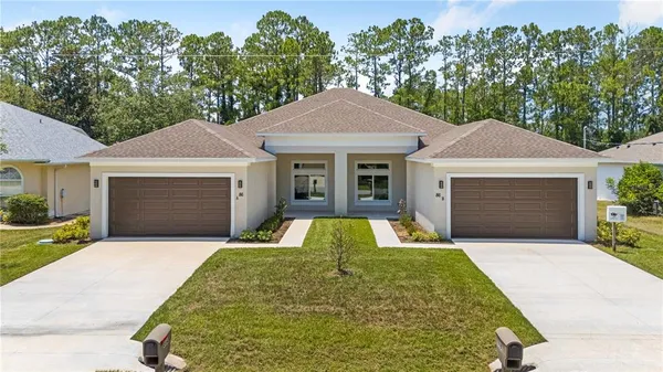 a front view of a house with yard and garage
