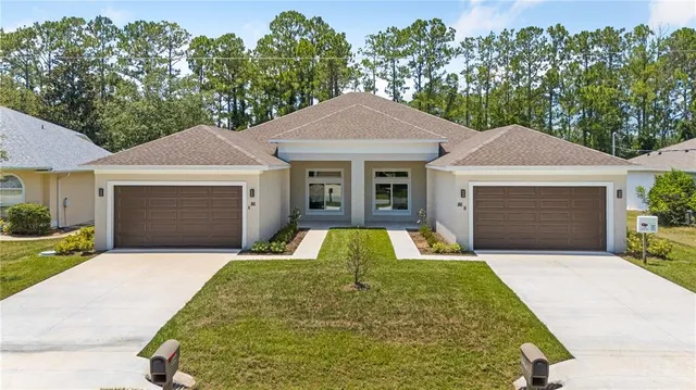 a front view of a house with yard and garage