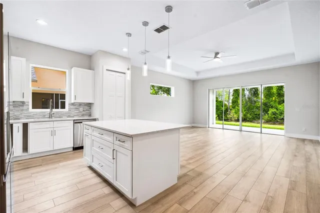 a kitchen with a stove window and wooden floor