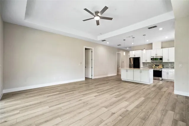 a view of kitchen with refrigerator microwave and stove
