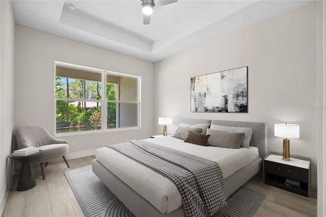 a bedroom with a bed and a large window