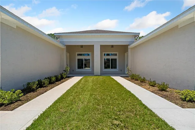 a view of a house with potted plants