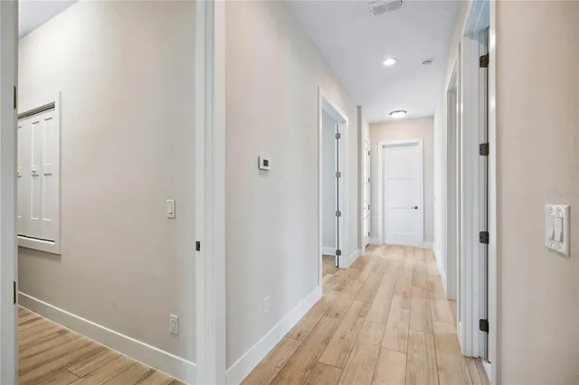 a view of a hallway with wooden floor