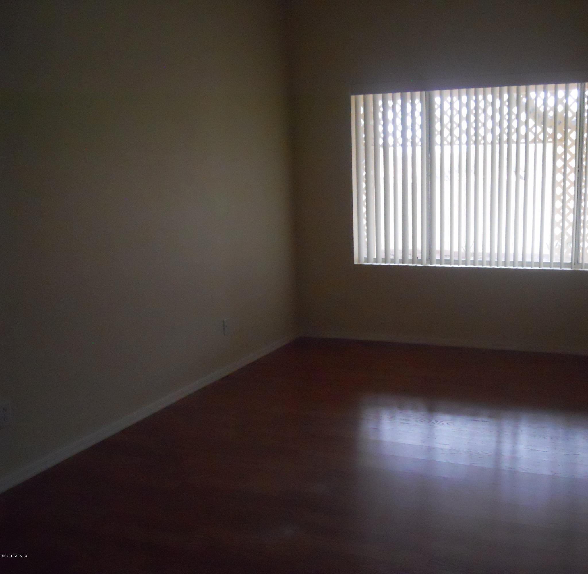 7736 East Elk Creek Road Tucson, AZ 85750 - Photo 5 of 11 an empty room with a window