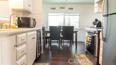 1134 Villa Calimesa Lane, Unit 42 Calimesa, CA 92320 - Photo 22 of 36 a kitchen with stainless steel appliances granite countertop a dining table chairs refrigerator and sink