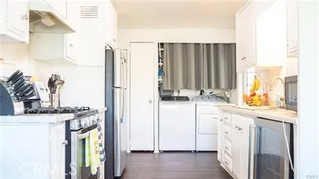 a bedroom with furniture and a wooden floor