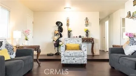 a living room with furniture a flat screen tv and a large window
