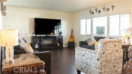 1134 Villa Calimesa Lane, Unit 42 Calimesa, CA 92320 - Photo 27 of 36 a living room with furniture a flat screen tv and a large window