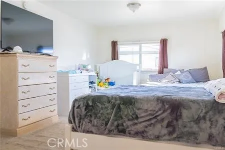 a bedroom with a bed and a night stand