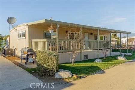 1134 Villa Calimesa Lane, Unit 42 Calimesa, CA 92320 - Photo 3 of 36 a view of a house with backyard and sitting area