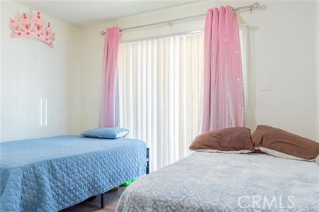 1134 Villa Calimesa Lane, Unit 42 Calimesa, CA 92320 - Photo 34 of 36 a bedroom with a bed and a window