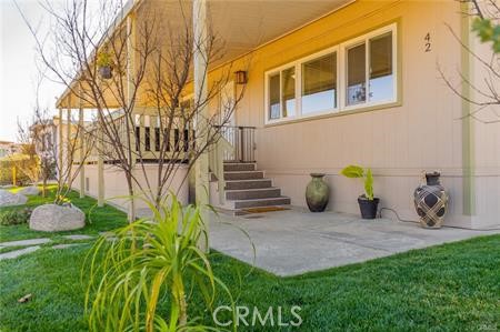 1134 Villa Calimesa Lane, Unit 42 Calimesa, CA 92320 - Photo 5 of 36 a view of a chair and table in backyard