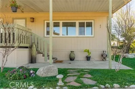 a view of a house with backyard sitting area and garden
