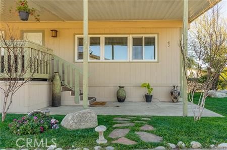 1134 Villa Calimesa Lane, Unit 42 Calimesa, CA 92320 - Photo 6 of 36 a view of a house with backyard sitting area and garden