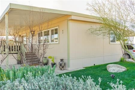 1134 Villa Calimesa Lane, Unit 42 Calimesa, CA 92320 - Photo 7 of 36 a backyard of a house with plants and a fountain